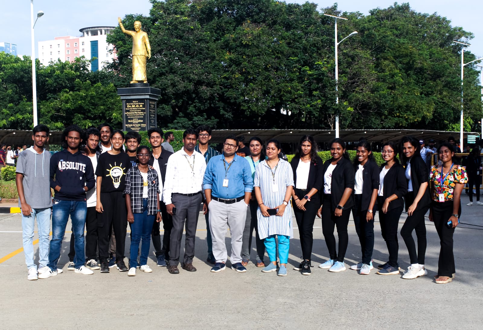 Dr. Pritam Bhowmik standing with student collaborators near the VIT campus statue