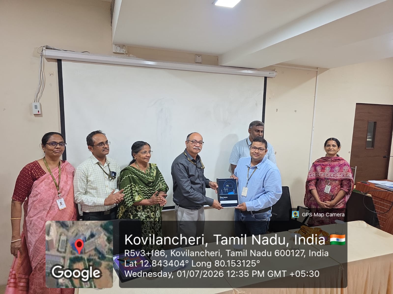 Dr. Pritam Bhowmik receiving a plaque during a school recognition moment